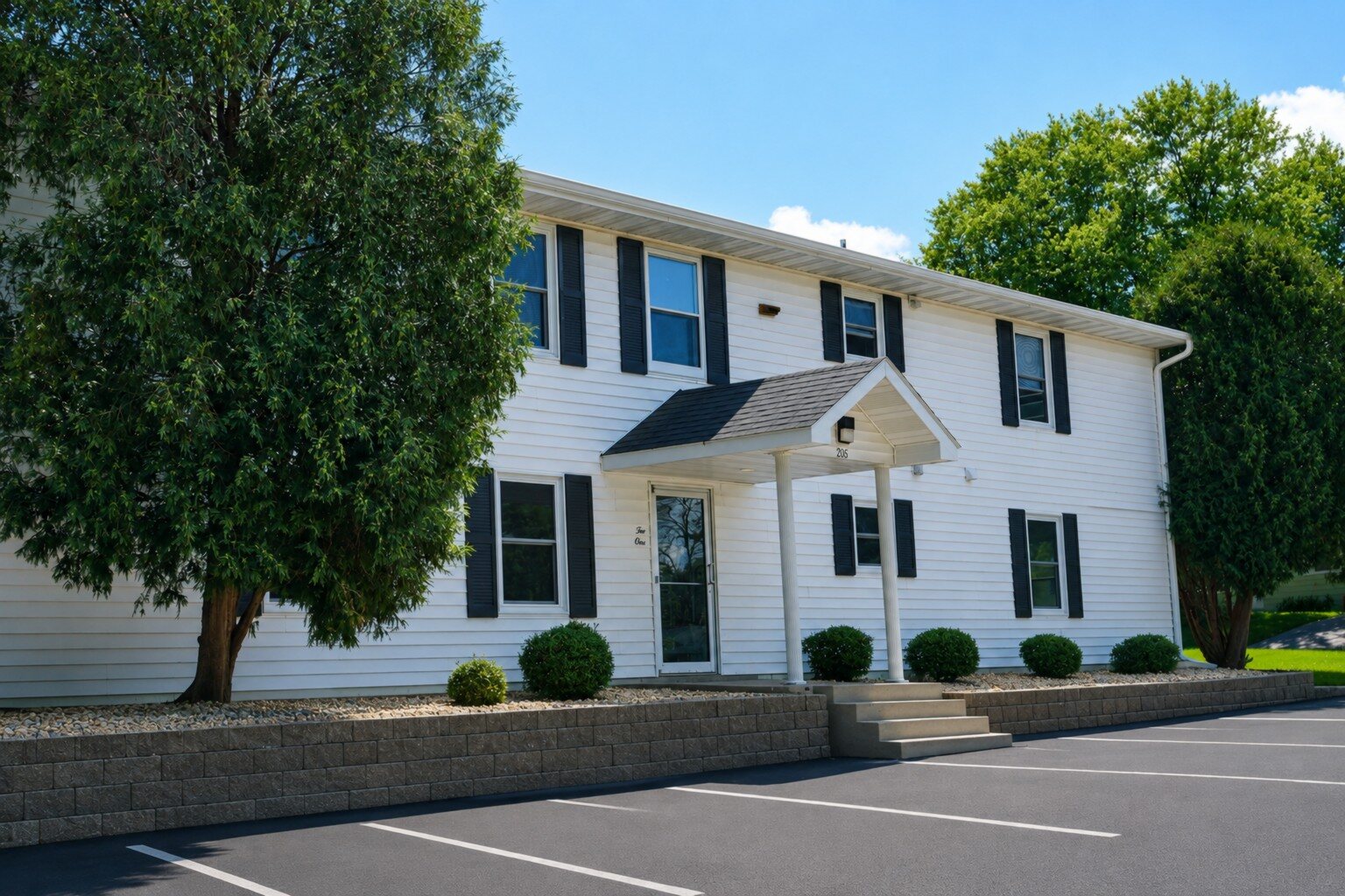 White exterior of The Grove apartments at 205 Walnut Street