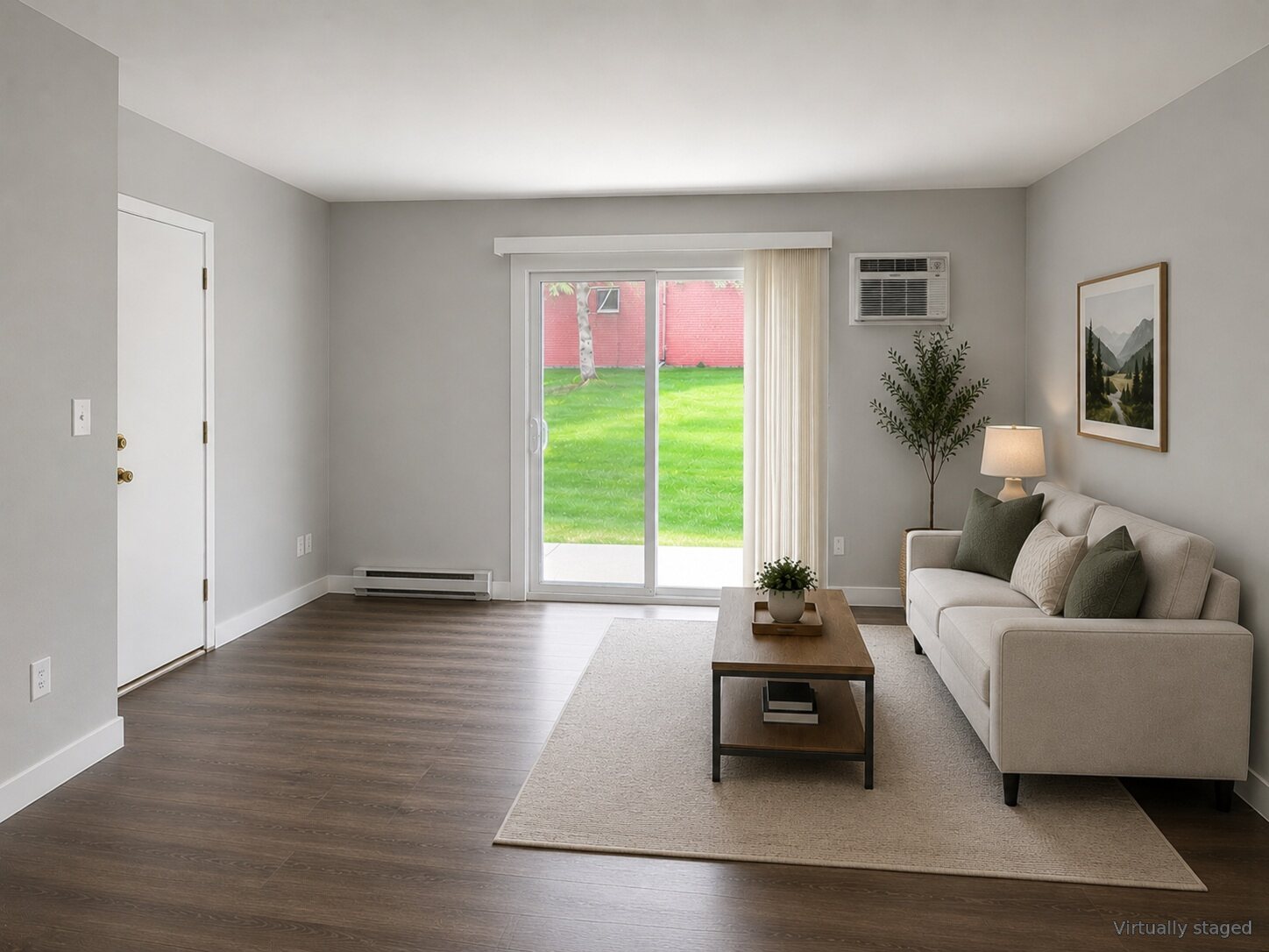 Living room and patio door at The Grove apartments, virtually staged
